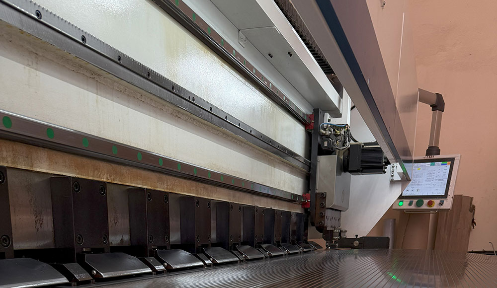 Industrial V-grooving machine operating in a metal fabrication workshop in Dubai